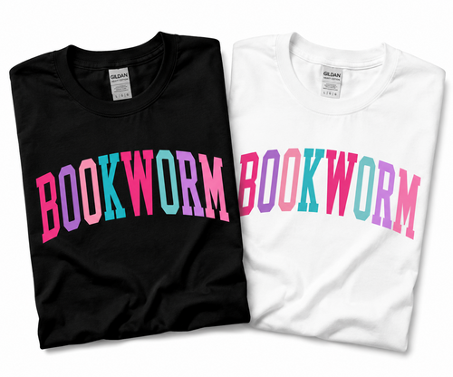 Folded black and white Gildan T-shirts with “BOOKWORM” in pink, purple, and turquoise varsity lettering.