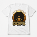 White Gildan T-shirt with a gold-and-black retro design reading “UNAPOLOGETICALLY DOPE” around a woman with an Afro and sunglasses.